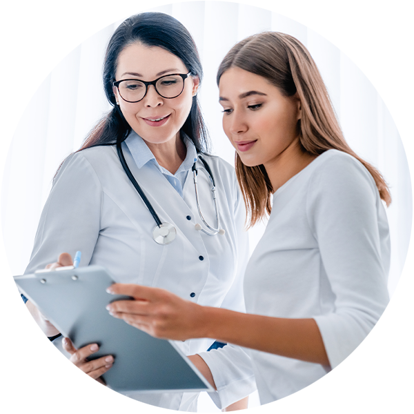 Two women, doctor and patient, looking at a clipboard