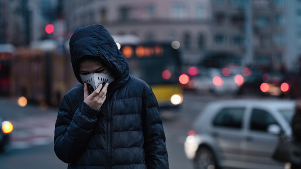 Boy on the City Street Wearing Anti-Pollution Mask